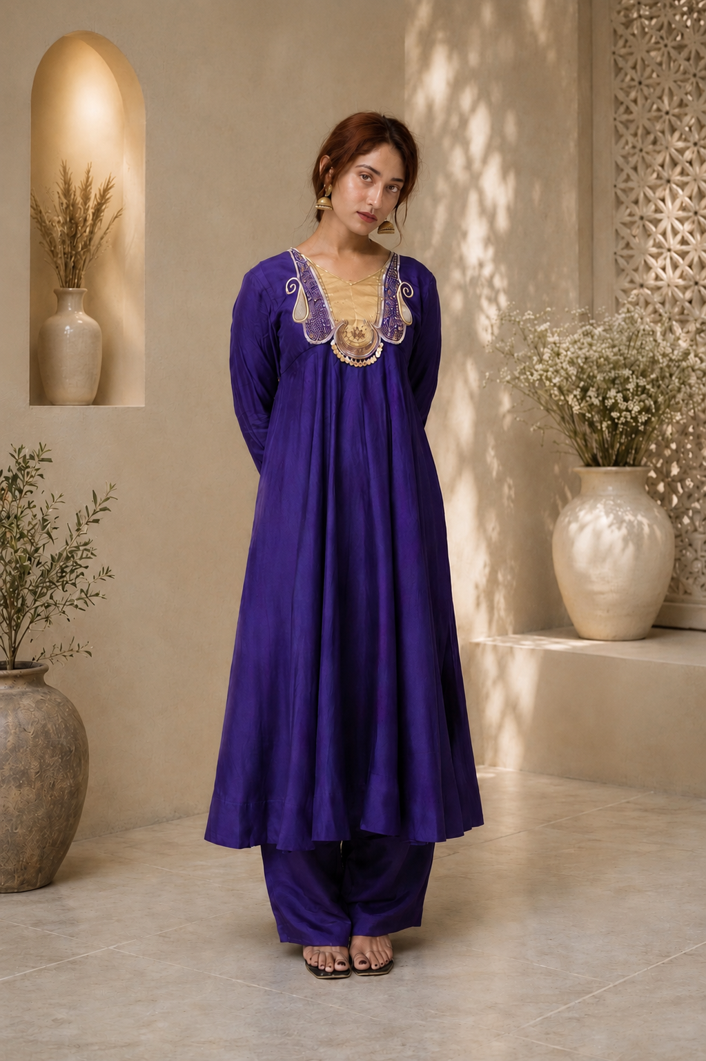Full-length royal purple Anarkali kurta set with gold neckline embroidery and matching pants